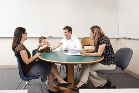 Family at table with school counselor